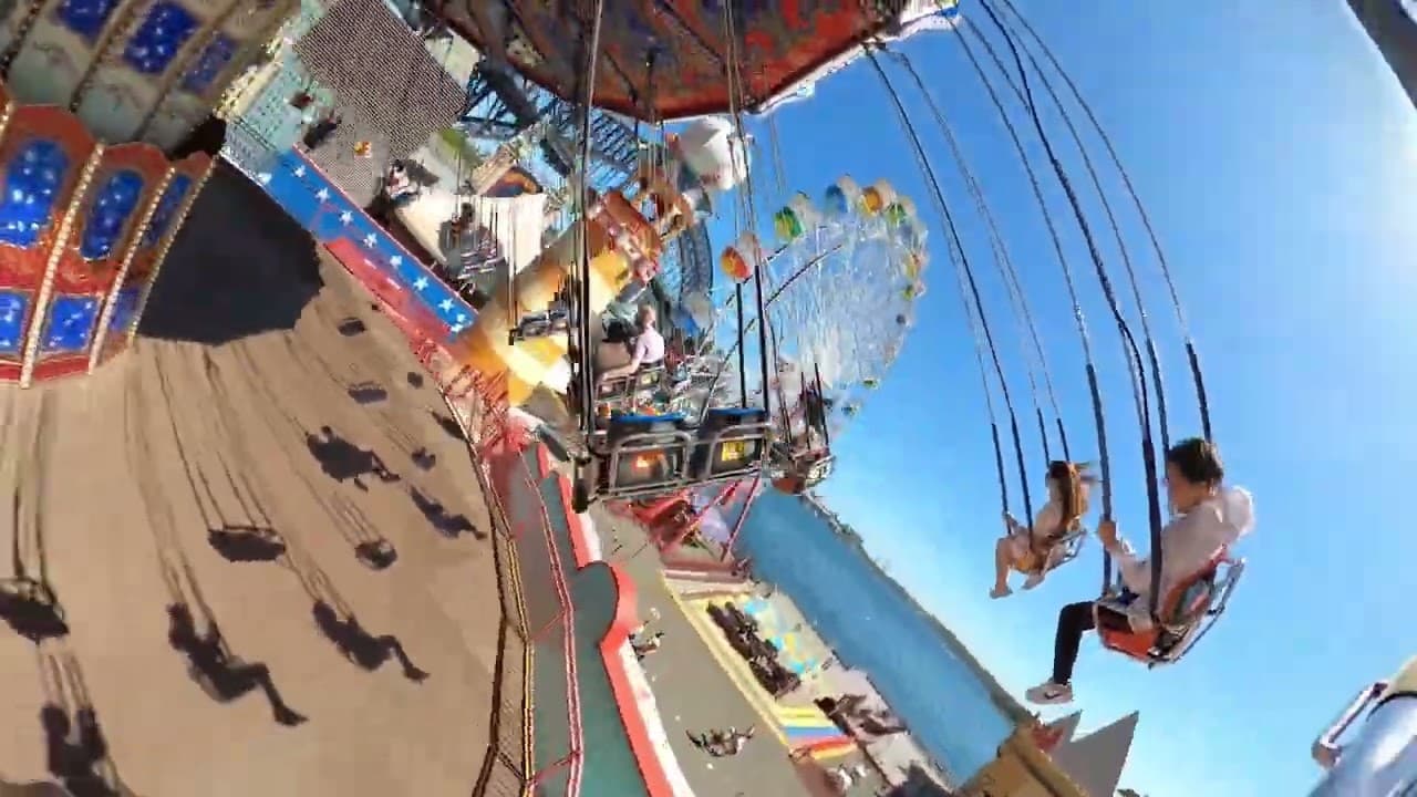 The Volaré wave-swinger ride with the Sydney Harbour Bridge behind it at Luna Park Sydney
