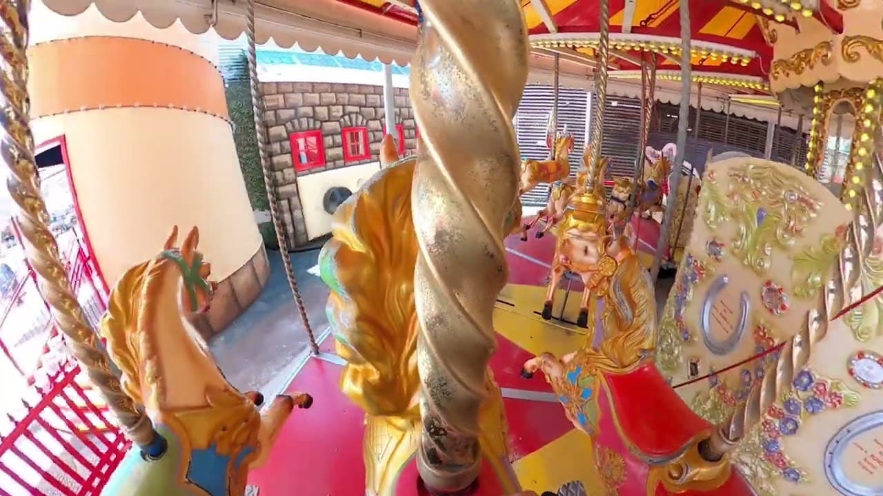 A child riding a horse on the Carousel at Luna Park Sydney